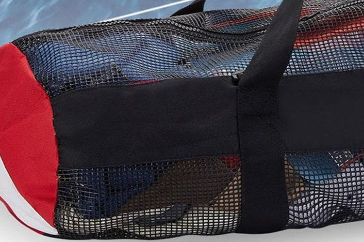 Mesh dive duffle bag packed with kit on a boat deck