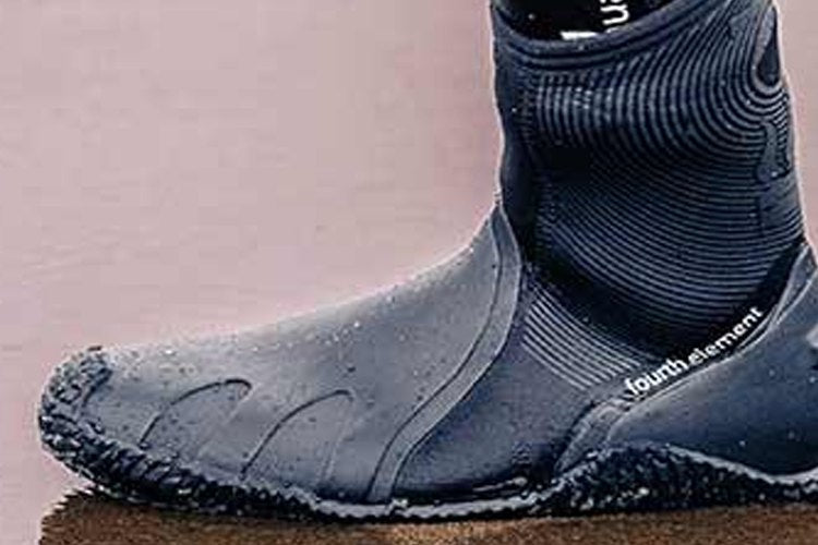 Neoprene dive boot with a moulded grip sole on wet sand
