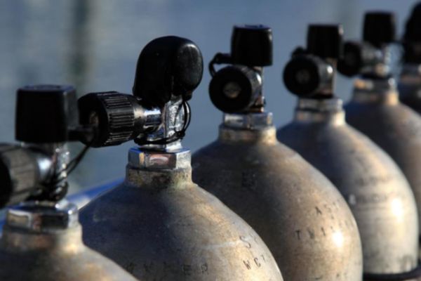 Row of diving cylinders showing cylinder valves