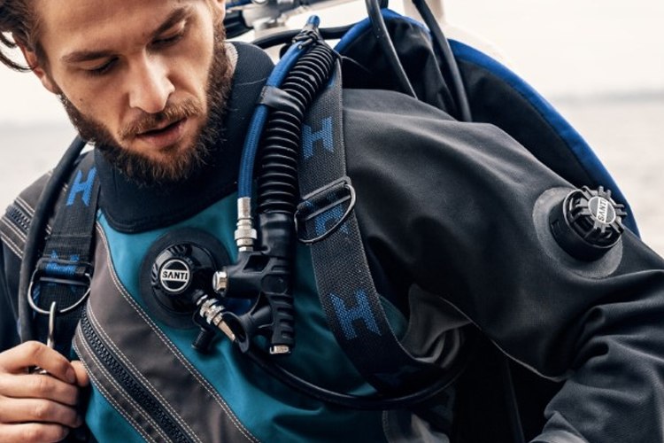 Diver in a Santi drysuit preparing to enter the water