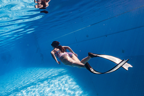 Female freediver training in a pool