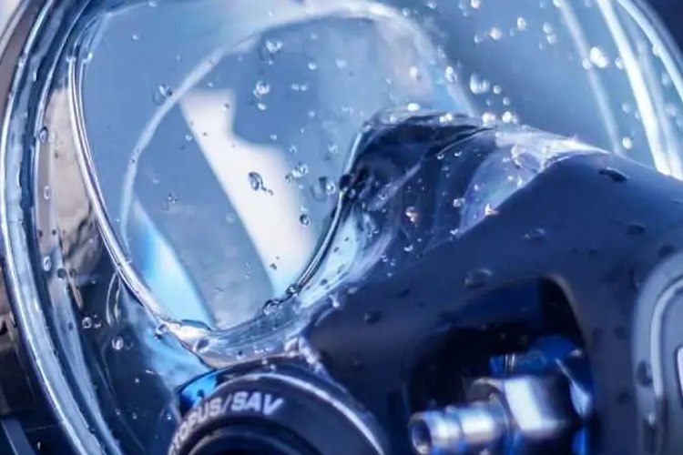 Close-up of an Ocean Reef full face dive mask visor and regulator block
