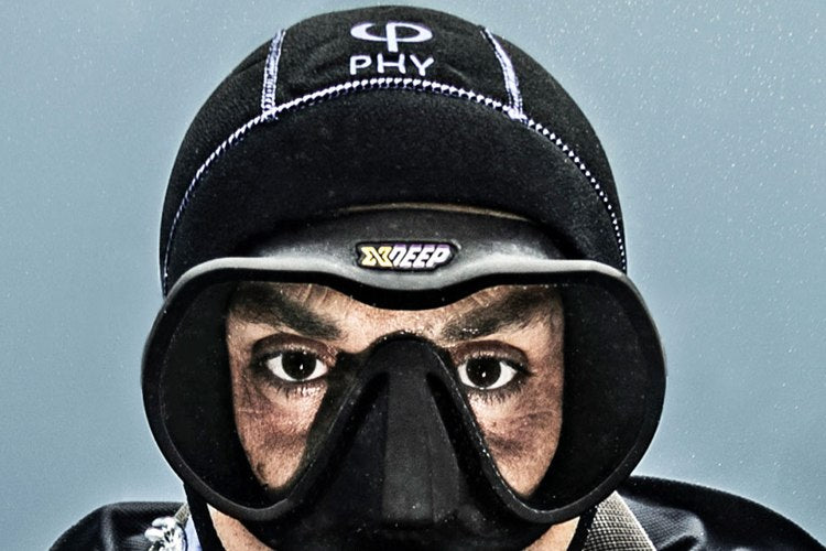 Diver wearing a neoprene hood and mask in cold water