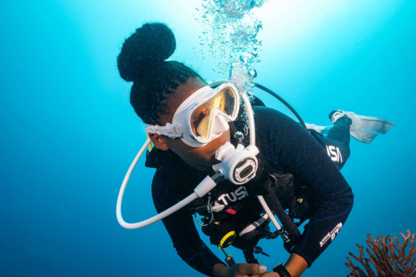 Female diver underwater wearing tusa dive equipment